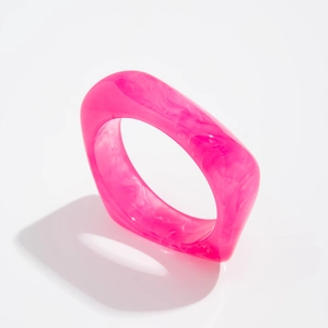 Detailed top view of pink marble resin ring with heavy rectangular geometric structure