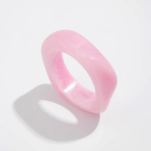 Detail of chunky resin ring with pink marble texture and irregular square design