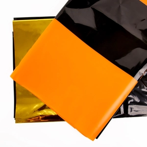 Disposable color-block tablecloth set in gold, orange and black for party decorations