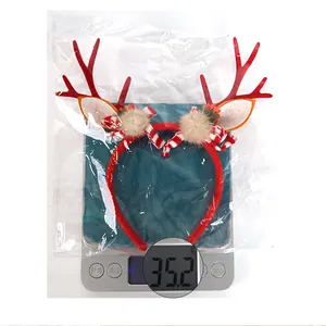 Detailed view of red Christmas reindeer antler headband weighing 35.2g in packaging