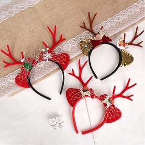 Detail of Christmas reindeer headbands with red mesh, gold sequins and snowflake patterns