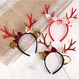 Close-up of Christmas reindeer antlers headband set with sequins and bow details