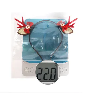 Detailed view of red Christmas reindeer antler headband showing lightweight 22.0g mass