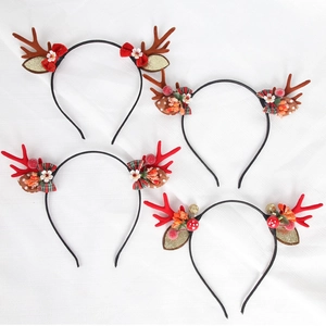 Detailed view of four festive Christmas antler headbands with flowers and berries
