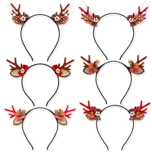Collection of six Christmas reindeer antler headbands with festive floral and bow decorations
