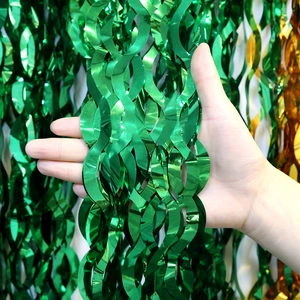 Detail of green wavy foil fringe curtain showing wide metallic tinsel texture for party