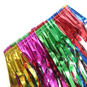 Close-up of metallic tinsel fringe foil curtains in gold, pink, green, red and blue colors