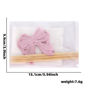 Detail view of pink glitter bow cake topper DIY kit with dimensions 15.1x9.9cm