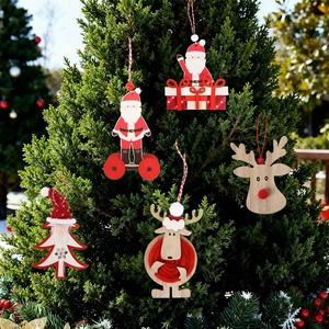 Detailed view of handmade wooden Christmas pendants including Santa and reindeer on tree