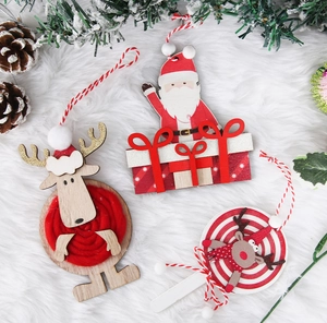 Detailed view of handmade wooden Christmas ornaments with red yarn and reindeer designs