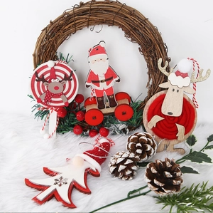 Close-up of Christmas wooden ornaments with reindeer and Santa on white faux fur background