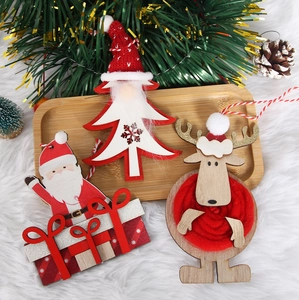 Close-up of wooden Christmas ornaments featuring Santa, gnome, and elk on a bamboo tray