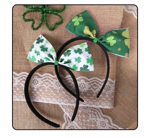 Detail of St. Patrick's Day headbands featuring green shamrock clover bowknots on rustic burlap