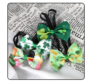 Detailed view of four St. Patrick's Day bow ties with shamrock patterns on vintage newsprint
