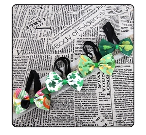 Detail of St. Patrick's Day hair bows featuring green shamrock prints and durable elastics