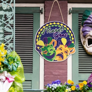 Mardi Gras round wooden sign with mask design and rustic rope on a brick wall background