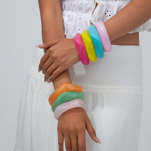 Set of seven colorful irregular resin bangles with marble texture and wavy organic design