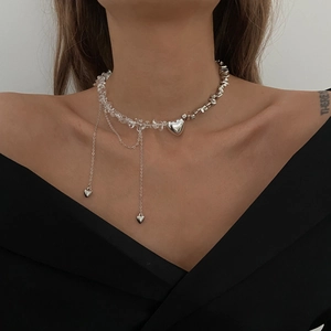 Dettaglio del ciondolo a cuore in argento e perle di cristallo sulla collana a strati