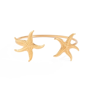 Gold open cuff bracelet featuring two textured starfish charms on a white background