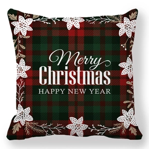 Macro shot of red and green plaid Christmas pillow cover with Merry Christmas text