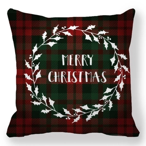 Detail of red and green tartan Christmas pillowcase with Merry Christmas wreath print