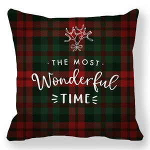Detail of Christmas plaid pillowcase featuring red green pattern and holiday text
