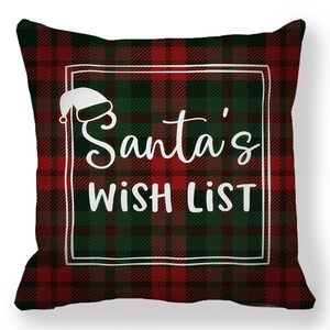 Close-up of red and green plaid Christmas pillow cover featuring Santa's Wish List text