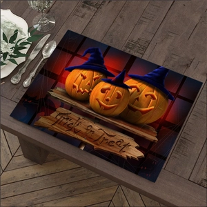 Detail of Halloween linen placemat featuring pumpkins and Trick or Treat lettering