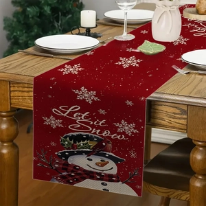 Linen Christmas table runner with snowman and Let it Snow text on a wooden table