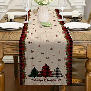 Detail of Christmas linen table runner with red plaid edges and Merry Christmas tree