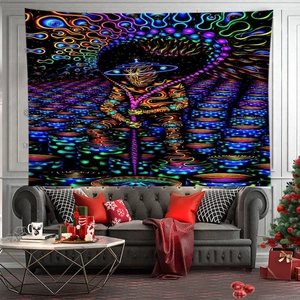 Detail of psychedelic astronaut wall tapestry hanging above a sofa in a modern room