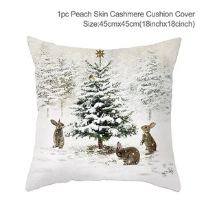 Detail of Christmas pillow cover featuring festive rabbit and tree print on peach skin fabric