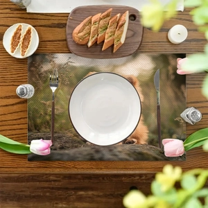 Linen placemat with realistic bear forest print on dark wood table with cutlery