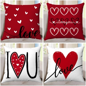 Detailed view of four Valentine pillow covers with red heart and love letter prints