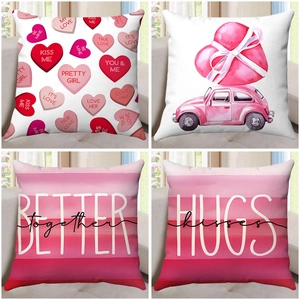 Detail view of four Valentine's Day pillow covers with heart prints and romantic quotes