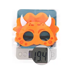 Orange triceratops felt mask for dinosaur parties with weight scale showing 19.4g