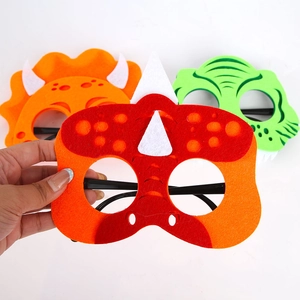 Detail of colorful felt dinosaur party glasses for children with creative animal shapes