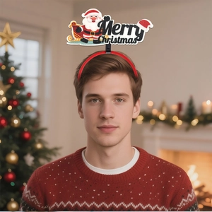 Man wearing red Merry Christmas headband with glitter Santa detail in a festive home setting