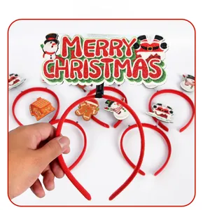 Close-up of a festive red headband featuring a Merry Christmas sign and glitter decorations