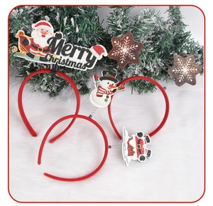 Close-up of three festive Christmas headbands with snowman and Santa decor on white fur