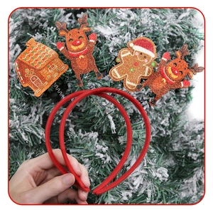 Detail of Christmas headband with glitter gingerbread house and reindeer ornaments