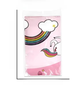 Flat view of pink unicorn tablecloth in plastic packaging with measurement markers