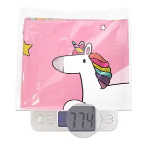 Pink unicorn party tablecloth weight display showing 77.4g on a digital scale