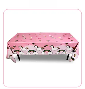 Pink unicorn party tablecloth with rainbow and donut prints for birthday decor