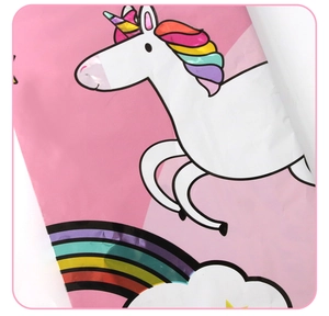 Detail of disposable pink unicorn and rainbow patterns on a PE plastic tablecloth