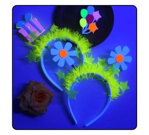 Detail of neon party headbands with glowing stars and flowers in UV light for parties
