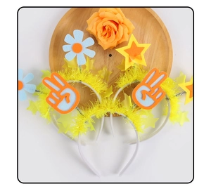Detail of yellow party headband featuring feathers, felt flowers, and star decorations