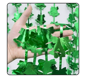 Close-up of green metallic bell garland decoration for festive Christmas party backdrops
