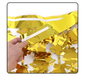 Detail of self-adhesive backing on golden Christmas bell tinsel curtain decoration