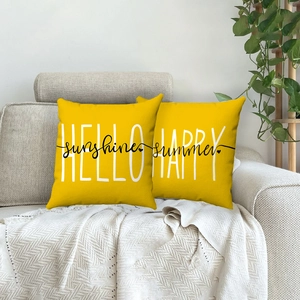 Yellow linen daisy pillows with 'Hello Sunshine' and 'Happy Summer' text on a gray sofa